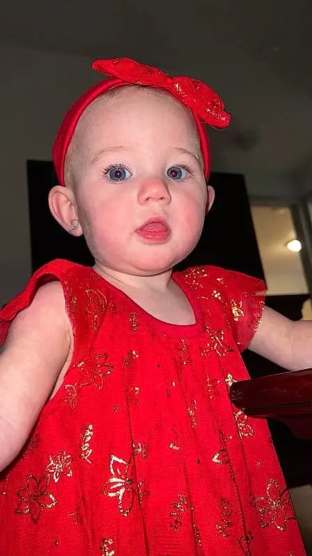 Face, Cheek, Lip, Cap, Baby & Toddler Clothing, Sleeve, Dress, Pink, Toddler, Headgear, Red, Baby, Costume Hat, Magenta, Happy, Pattern, Child, Event, Hat, Fashion Accessory, Person