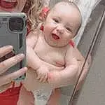 Cheek, Skin, Lip, Chin, Smile, Baby & Toddler Clothing, Pink, Finger, Baby, Camera, Toddler, Digital Camera, Photographer, Camera Lens, Thumb, Child, Point-and-shoot Camera, Communication Device, Single-lens Reflex Camera, Person