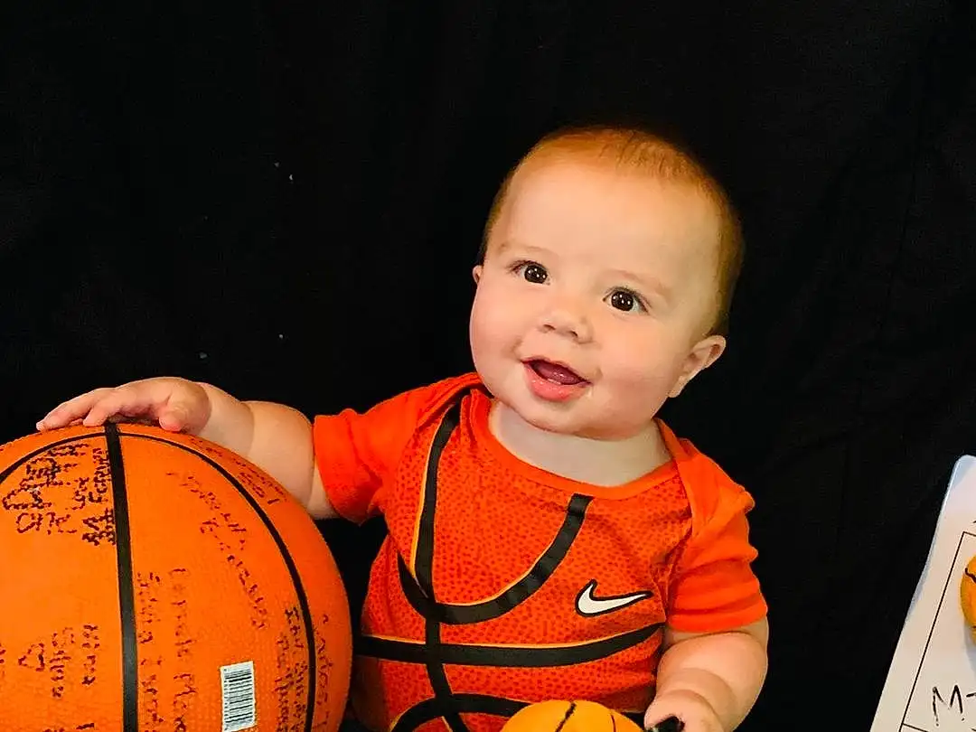 Sports Equipment, Shorts, Orange, Smile, Ball, Yellow, Fun, Sports Toy, Toddler, Baby, T-shirt, Personal Protective Equipment, Football, Player, Knee, Basketball, Ball Game, Happy, Room, Sportswear, Person, Joy