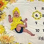 Smile, Facial Expression, Nature, Happy, People In Nature, Yellow, Art, Plant, Flower, Font, Pattern, Toddler, Illustration, Baby, Grass, Petal, Child, Fun, Floral Design, Leisure, Person, Headwear