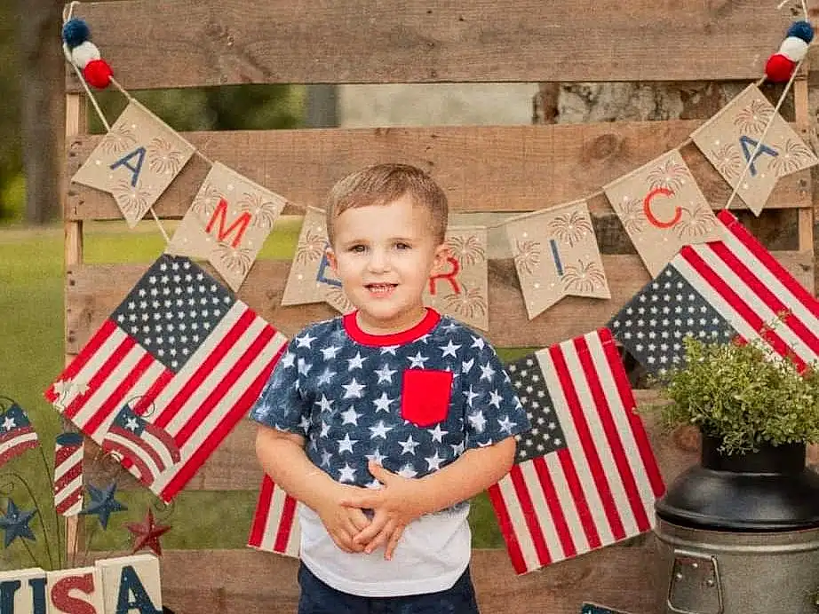 Photograph, White, Window, Shorts, Flag Of The United States, Smile, Flag, Red, Summer, People, Flag Day (usa), Event, Holiday, Grass, Recreation, Pattern, Child, Toddler, T-shirt, Plaid, Person, Joy