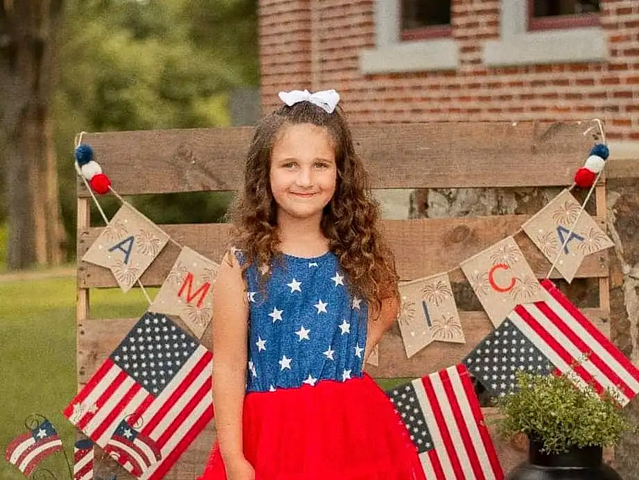 Smile, Window, Fashion, Flag Of The United States, Dress, Pink, Plant, Red, Summer, Grass, Event, Recreation, Flag, Pattern, Flag Day (usa), Electric Blue, Day Dress, Holiday, Plaid, Child, Person, Joy