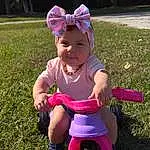 Face, Tire, Wheel, Bicycle, Baby & Toddler Clothing, Plant, Riding Toy, Pink, People In Nature, Grass, Toddler, Baby, Happy, Fun, Goggles, Magenta, Lawn, Child, Recreation, Personal Protective Equipment, Person, Headwear