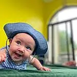 Skin, Smile, Hat, Window, Sun Hat, Flash Photography, Happy, Yellow, Cap, Toddler, Fun, Baby, Leisure, Baby & Toddler Clothing, Child, Grass, Sitting, Recreation, Fashion Accessory, Play, Person, Headwear