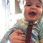 Hairstyle, Smile, Sleeve, Textile, Happy, Baby & Toddler Clothing, Tie, Pattern, Toddler, Button, Baby, Curtain, Child, Nail, Chest, Uniform, Fun, Musical Instrument, Laugh, Plaid, Person