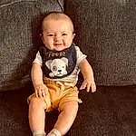 Skin, Head, Smile, Arm, Eyes, Leg, Comfort, Baby & Toddler Clothing, Flash Photography, Sleeve, Iris, Finger, Knee, Thigh, Baby, Couch, Happy, Shorts, T-shirt, Person