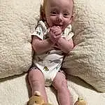 Cheek, Skin, Head, Arm, Photograph, Eyes, White, Smile, Leg, Toy, Comfort, Baby & Toddler Clothing, Textile, Fawn, Baby, Toddler, Happy, Thigh, Child, Linens, Person