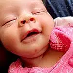 Face, Nose, Cheek, Skin, Lip, Chin, Mouth, Baby & Toddler Clothing, Neck, Baby, Textile, Smile, Pink, Happy, Gesture, Toddler, Sleeve, Eyelash, Magenta, Close-up, Person