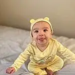 Clothing, Face, Cheek, Smile, Baby & Toddler Clothing, Sleeve, Happy, Iris, Baby, Toddler, Comfort, Fun, Child, Sitting, Portrait Photography, Laugh, Linens, Room, Flash Photography, Peach, Person, Headwear